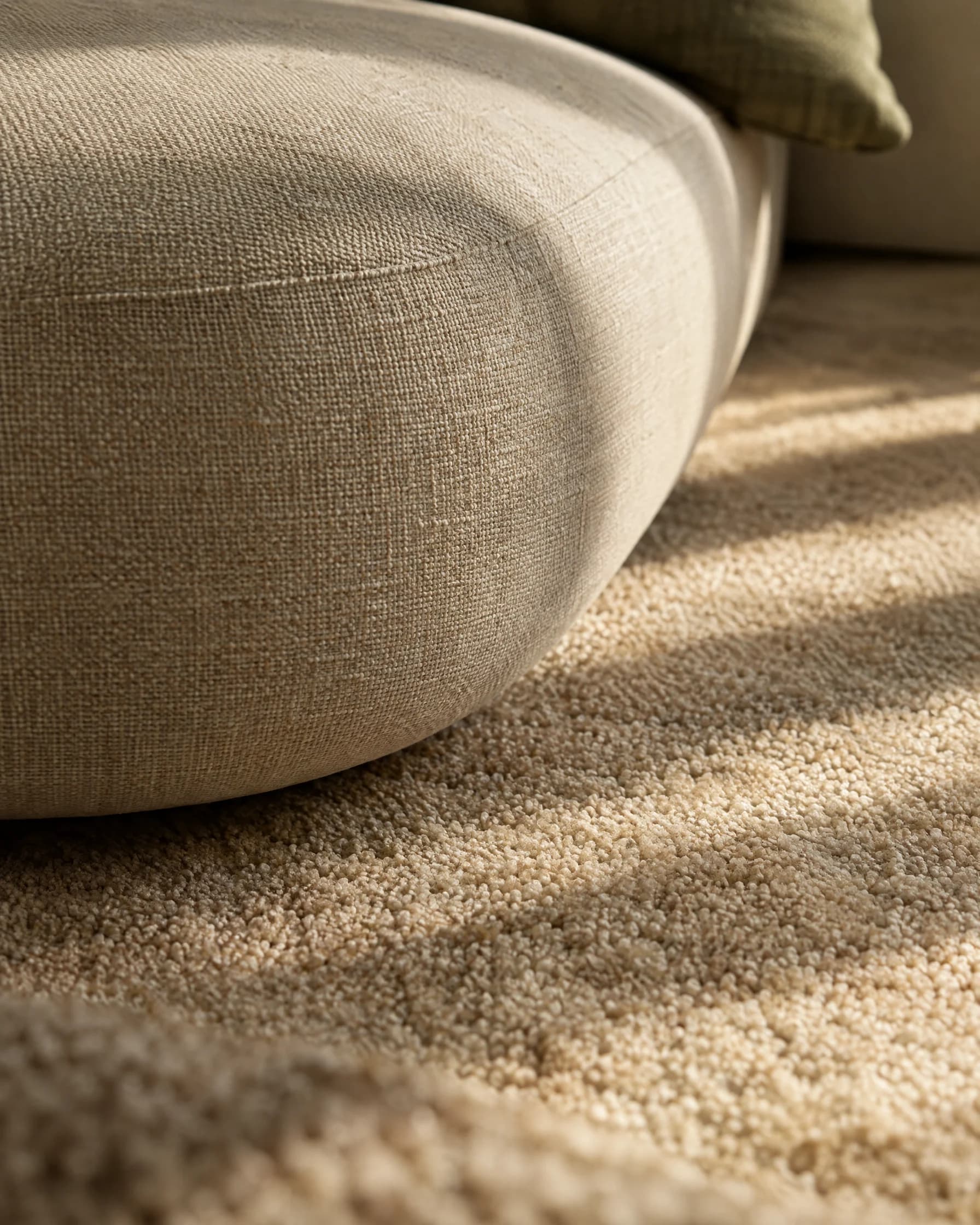 Woven upholstery and textured carpet in soft daylight